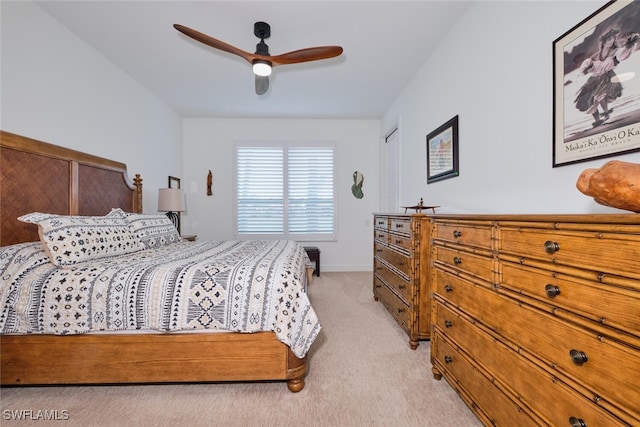 bedroom with baseboards, a ceiling fan, and light colored carpet