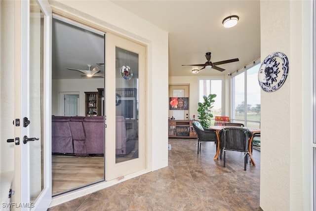 sunroom with ceiling fan and french doors