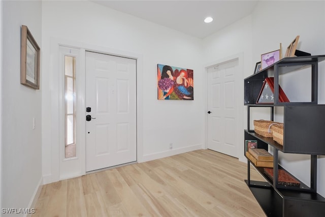 foyer with recessed lighting, baseboards, and wood finished floors