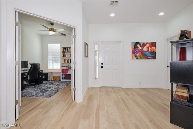 foyer entrance with light wood finished floors, baseboards, visible vents, and recessed lighting