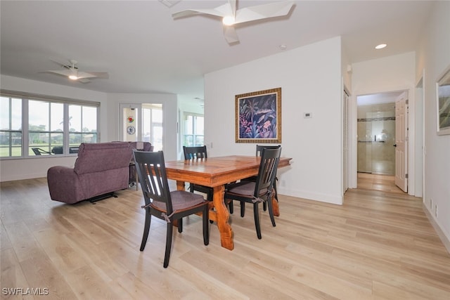 dining space with light wood finished floors, recessed lighting, a ceiling fan, and baseboards