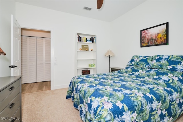 carpeted bedroom featuring ceiling fan and visible vents