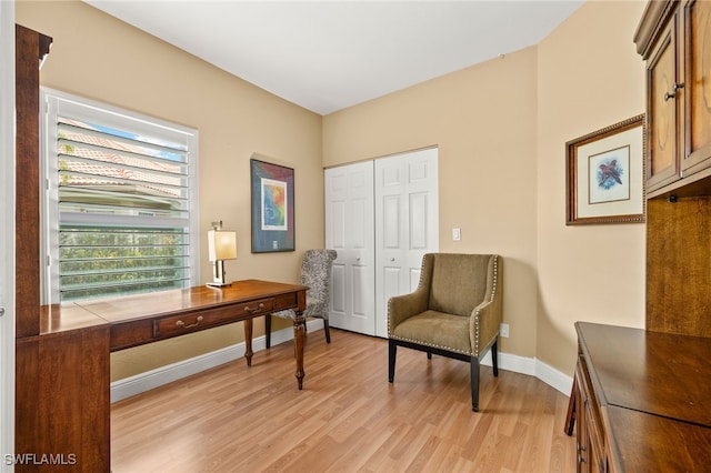 sitting room featuring baseboards and light wood finished floors