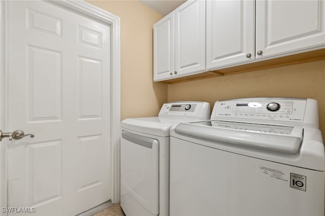 laundry area featuring cabinet space and separate washer and dryer