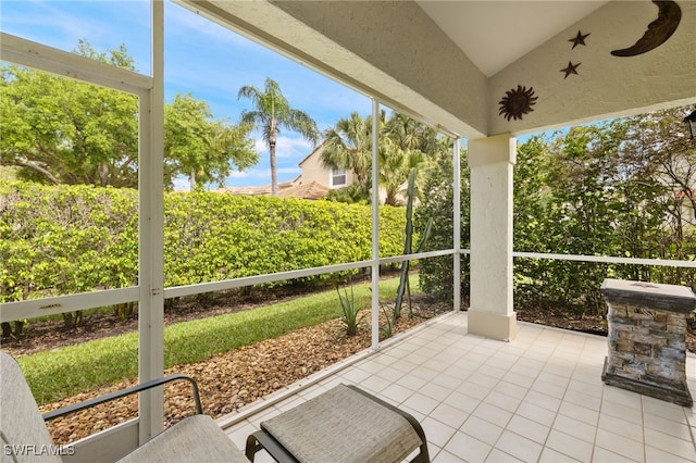 unfurnished sunroom with lofted ceiling