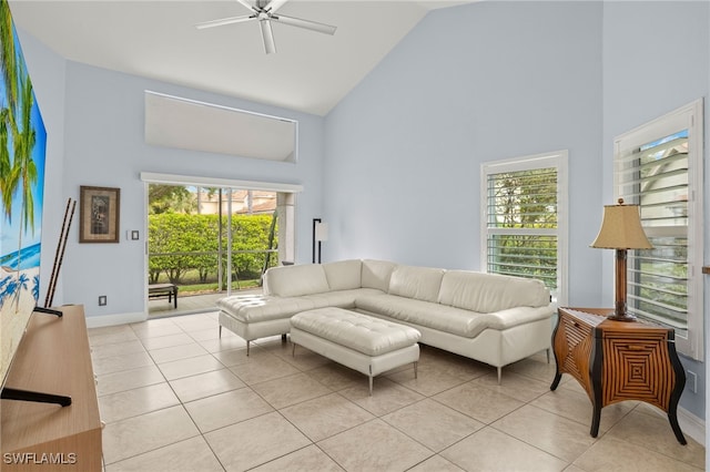 living room featuring high vaulted ceiling, ceiling fan, baseboards, and light tile patterned floors