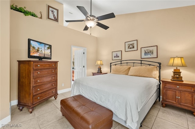 bedroom with light tile patterned floors, ceiling fan, and baseboards