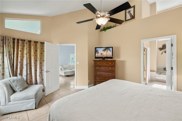 bedroom featuring baseboards, a ceiling fan, connected bathroom, high vaulted ceiling, and light tile patterned flooring