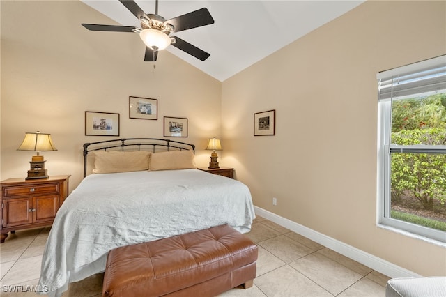 bedroom with vaulted ceiling, light tile patterned flooring, a ceiling fan, and baseboards