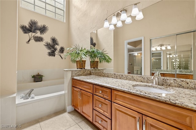 full bath with a bath, a shower stall, vanity, and tile patterned floors