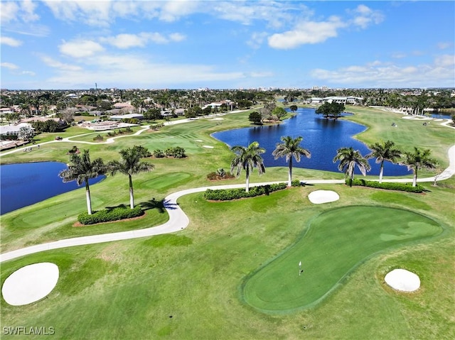 aerial view featuring golf course view and a water view