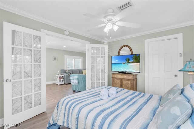 bedroom featuring ceiling fan, wood finished floors, visible vents, french doors, and crown molding