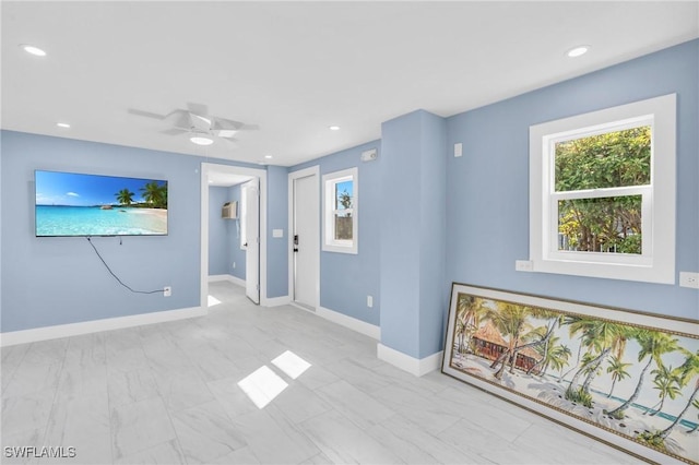 interior space featuring baseboards, a ceiling fan, a wall unit AC, marble finish floor, and recessed lighting