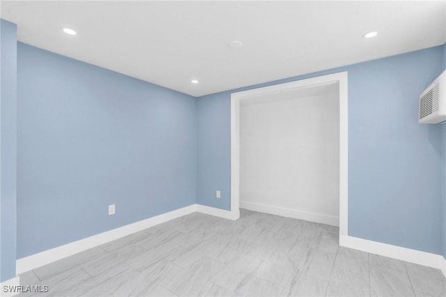 unfurnished bedroom featuring baseboards, a closet, and recessed lighting