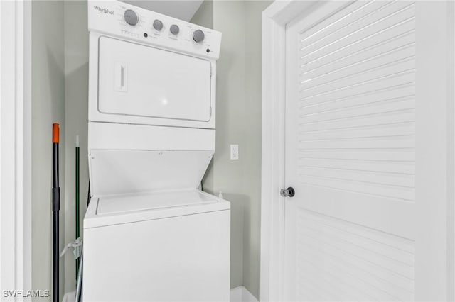 clothes washing area with laundry area and stacked washer / drying machine