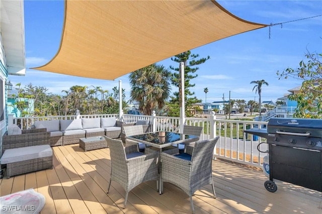 wooden terrace featuring outdoor dining area and an outdoor hangout area