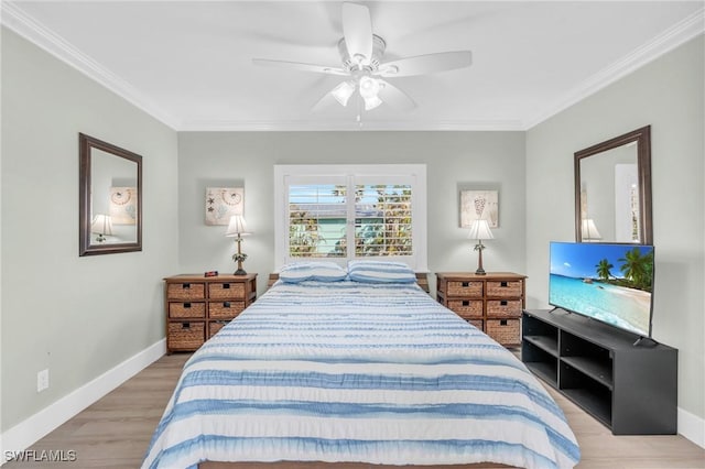 bedroom with light wood-type flooring, crown molding, baseboards, and ceiling fan