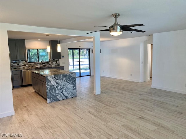 81 Cardinal Dr, North Fort Myers, FL 33917 - kitchen with dishwasher, open floor plan, light wood-type flooring, and backsplash
