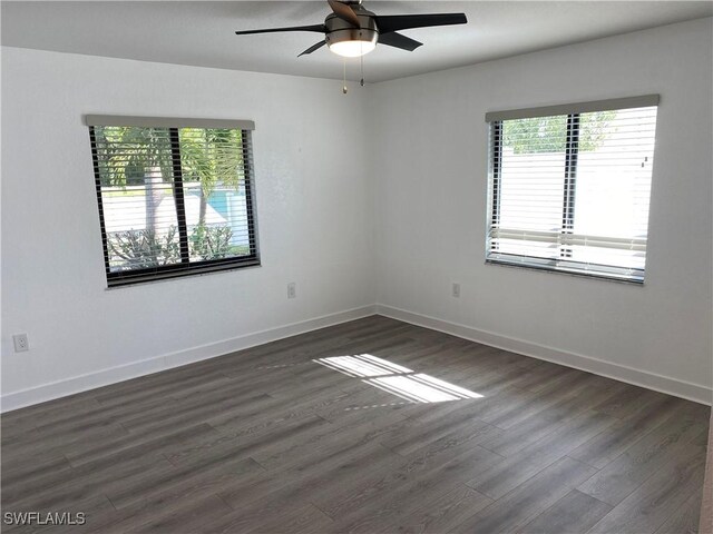 81 Cardinal Dr, North Fort Myers, FL 33917 - spare room featuring dark wood-style floors, baseboards, and a ceiling fan
