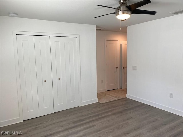 81 Cardinal Dr, North Fort Myers, FL 33917 - unfurnished bedroom with visible vents, a closet, baseboards, and wood finished floors