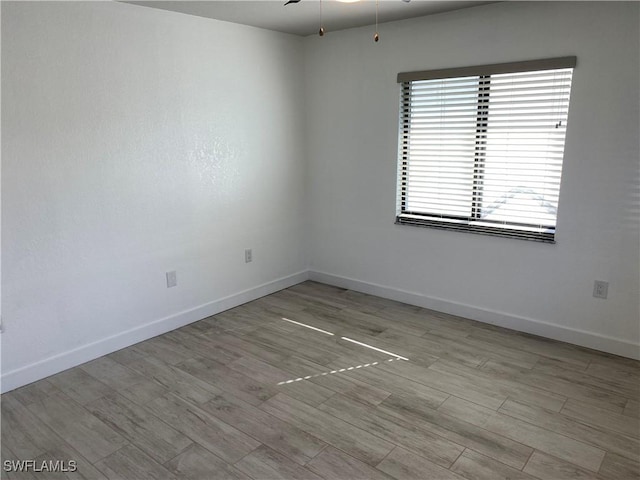 81 Cardinal Dr, North Fort Myers, FL 33917 - spare room with ceiling fan, baseboards, and wood finished floors