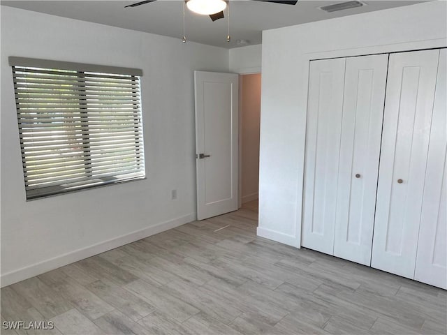 81 Cardinal Dr, North Fort Myers, FL 33917 - unfurnished bedroom with visible vents, baseboards, ceiling fan, light wood-type flooring, and a closet