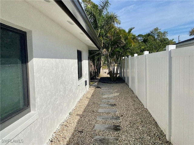 81 Cardinal Dr, North Fort Myers, FL 33917 - view of side of property with fence and stucco siding