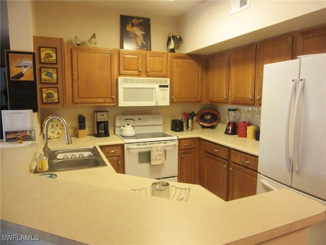 kitchen with light countertops, white appliances, brown cabinetry, and a sink