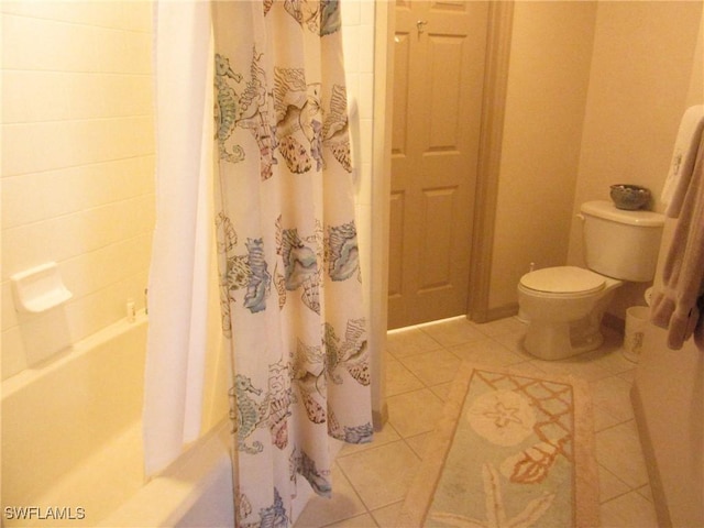 full bathroom featuring tile patterned flooring, shower / bathtub combination with curtain, and toilet