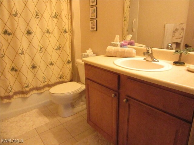 full bath with shower / tub combo, vanity, toilet, and tile patterned floors