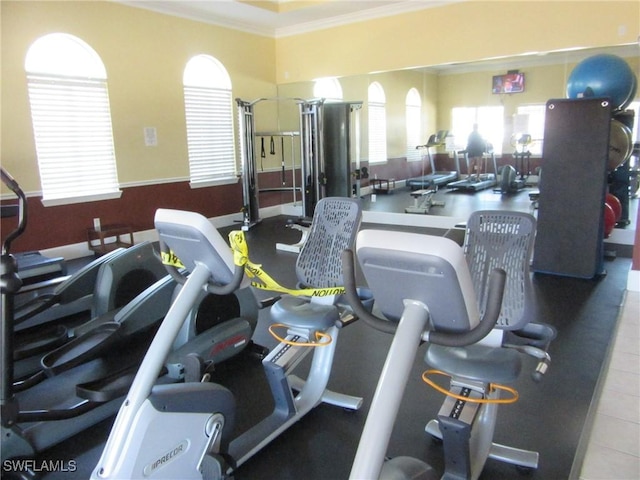 workout area featuring crown molding
