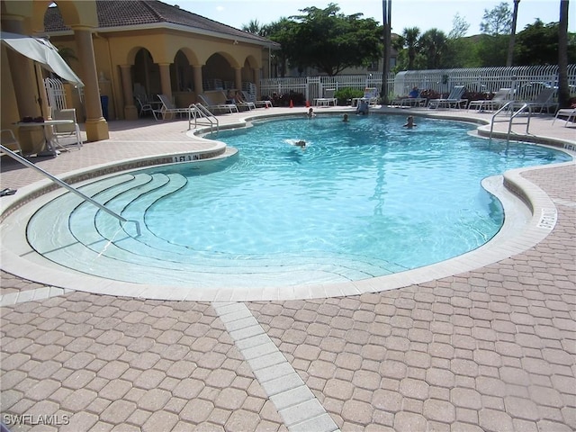 pool featuring a patio and fence