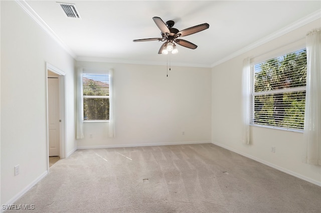 spare room featuring visible vents, crown molding, light carpet, and baseboards