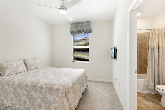 bedroom featuring baseboards, a ceiling fan, and light colored carpet