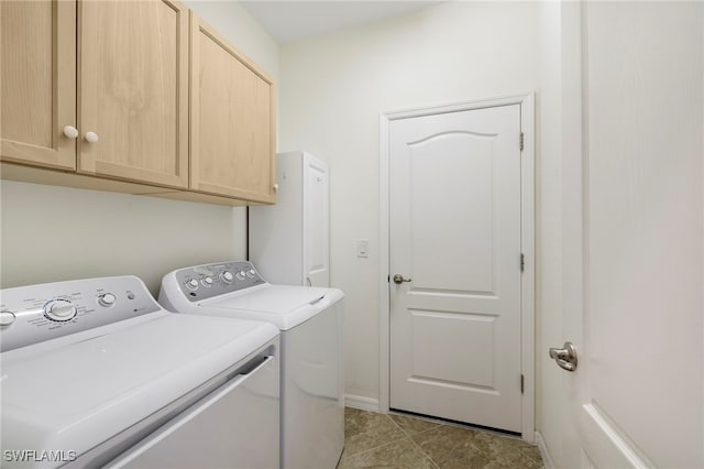 laundry area featuring washing machine and dryer and cabinet space