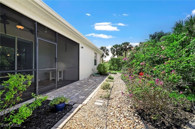 view of yard with a sunroom and a patio area