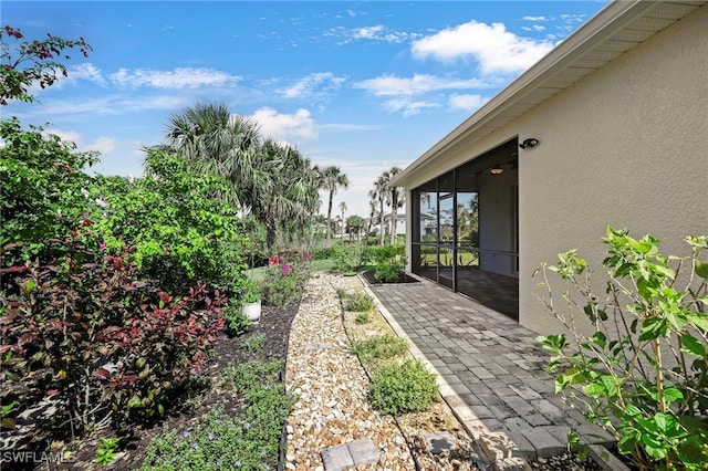 view of yard featuring a patio area and a sunroom