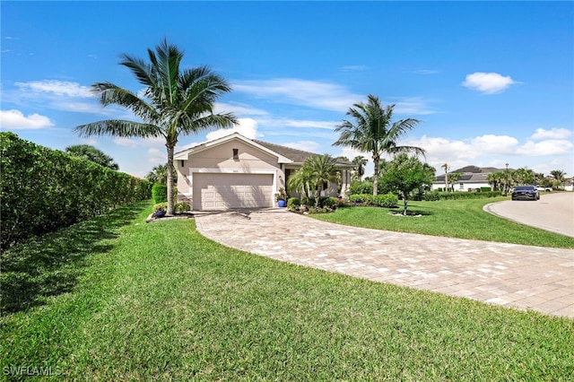 view of front of home featuring a garage, a front yard, driveway, and stucco siding