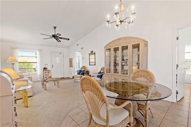 17862 Dracena Cir, North Fort Myers, FL 33917 - dining space with light tile patterned floors, high vaulted ceiling, and ceiling fan with notable chandelier