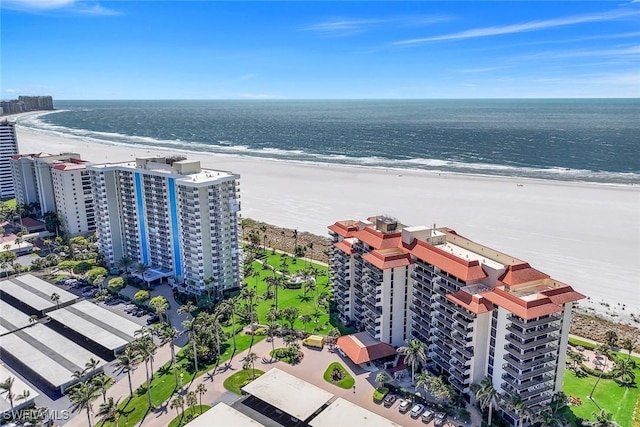 aerial view with a water view, a view of the beach, and a city view