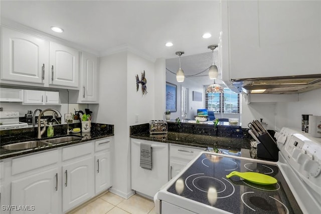 kitchen with dark stone counters, electric range, a sink, and white cabinets