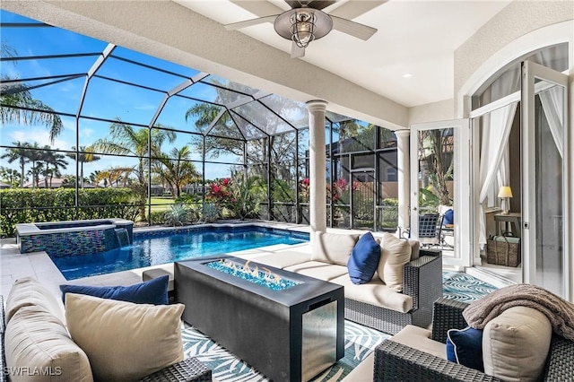 view of swimming pool with an outdoor living space with a fire pit, glass enclosure, a patio area, and ceiling fan