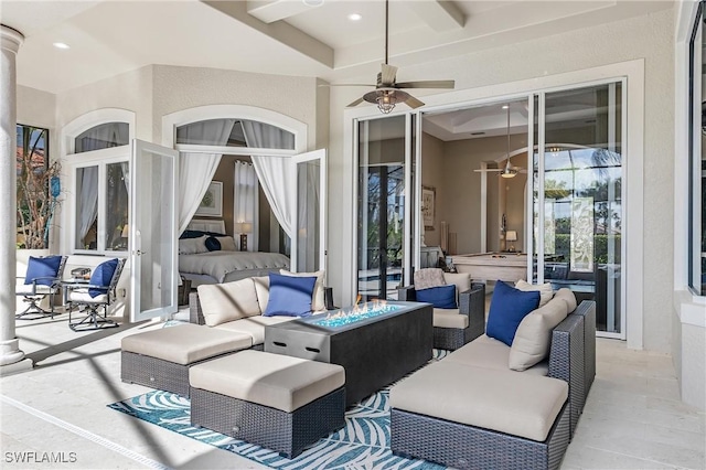 view of patio with an outdoor living space with a fire pit and a ceiling fan