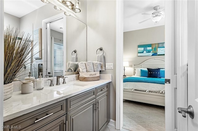 bathroom with vanity, ensuite bath, and a ceiling fan