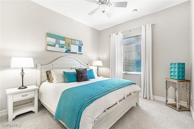 carpeted bedroom with ceiling fan and baseboards