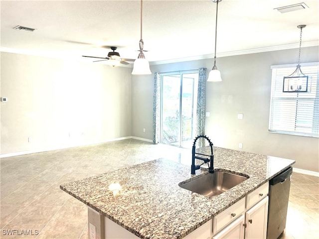 kitchen with visible vents, a sink, stainless steel dishwasher, hanging light fixtures, and a kitchen island with sink