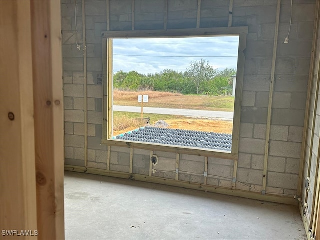 doorway with concrete block wall and concrete floors