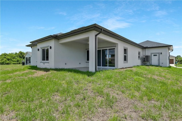 13224 Foresman Blvd, Port Charlotte, FL 33981 - rear view of house with stucco siding and a lawn