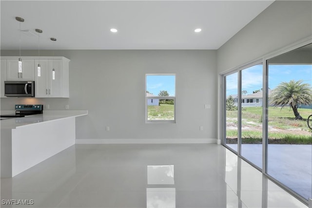 13224 Foresman Blvd, Port Charlotte, FL 33981 - unfurnished living room featuring healthy amount of natural light, light tile patterned floors, and recessed lighting