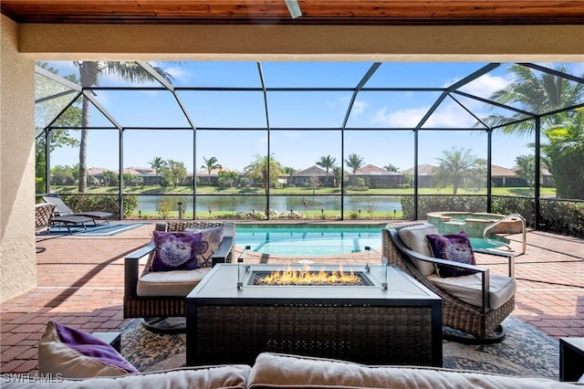 view of patio / terrace with glass enclosure, an outdoor living space with a fire pit, a water view, and an outdoor pool